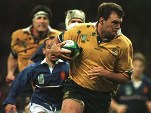 Ex-Wallaby Owen Finegan breaking through a tackle