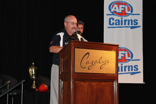 Andy Smith accepts Cairns AFL life membership.