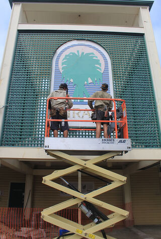 Papillon workmen remove the Mirage sign.