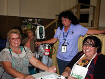 Wendy Widdison (from Cooktown) has her blood sugar taken by QLD Health's Eunice Smith and Leiha Walker.