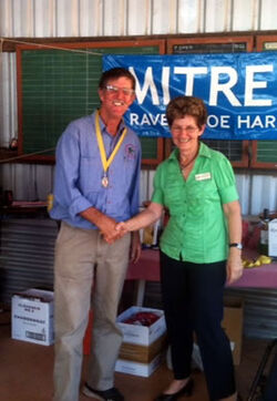 Neil Attwood accepting his medal from Tablelands Regional Council Councillor Sharon Linwood for his win at 600 yards on Sunday.