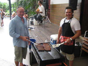 Justin (on right) with his mate helping cook the BBQ at the fundraiser