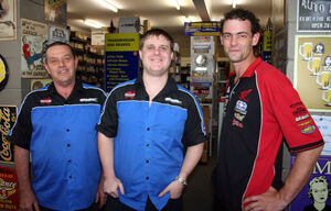 Damien McKechnie (centre) and his Mossman Auto co-workers. PIC Rosie Wang