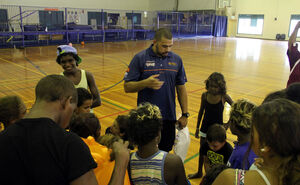 Skytrans Cairns Taipans Community Development Manager and former player Kerry Williams sharing hard won knowledge with the kids. (Pic: Apunipima Cape York Health Council)